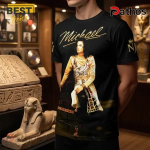 Michael Jackson King of Pop Gold Photo T-Shirt 1 Black crewneck t-shirt featuring a gold graphic of Michael Jackson in Egyptian-style attire with MJ crown logo on sleeve.!