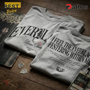 Lorna Shore Everblack Australia 2026 Tour T-Shirt 1 Grey Lorna Shore band t-shirts featuring Everblack typography and song tracklists on wooden surface with guitar picks.!