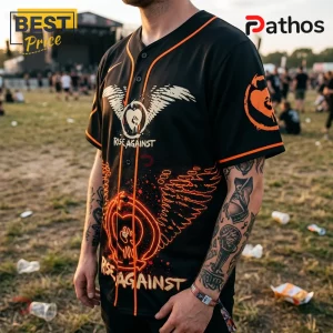 Black baseball jersey with orange trim featuring Rise Against logo, wings graphic, and text on a festival background.!