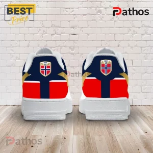 Norway National Team 2026 Gold Swoosh AF1 Sneakers 1 Rear view of white sneakers featuring Norway flag graphic, gold accents, and a Norway shield emblem on a brick background.!