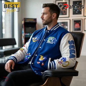 Man wearing a blue and white Sonic the Hedgehog 35th anniversary varsity jacket with embroidered Sega and character patches.!