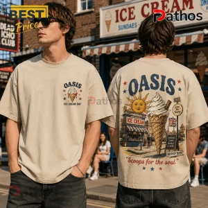 Oasis Ice Cream Day Cream T-Shirt 2026 2 Man wearing a cream-colored t-shirt with Oasis ice cream graphics, sun illustration, and Britpop Blvd text on the back.!