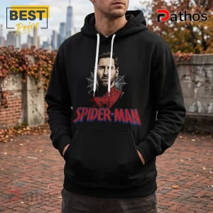 Messi x Spider-Man 2026 Edition Black Hoodie 1 Black hooded sweatshirt featuring a graphic of Lionel Messi as Spider-Man with white drawstrings on a brick background.!