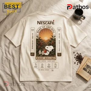 Nescafe x Snoopy Wake Up and Roll Cream T-Shirt 5 Off-white crewneck t-shirt featuring a Snoopy coffee graphic, sunset scenery, and Nescafé branding on the back.!