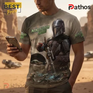 Tan crew neck t-shirt featuring The Mandalorian and Grogu graphic, digital desert print, and Star Wars branding.!