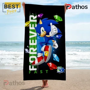 Sonic the Hedgehog 35th Anniversary Fast Forever Beach Towel 3 Sonic the Hedgehog beach towel with Forever Fast text, 35th Anniversary logo, and multicolored chaos emeralds.!