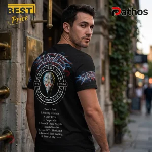 Man wearing black Eagles band t-shirt with 50th anniversary graphic, skull logo, and tracklist on back.!