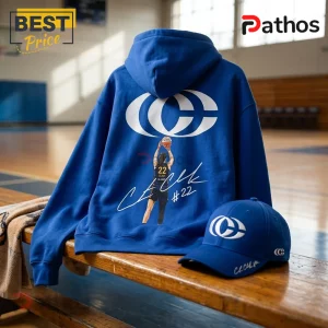 Caitlin Clark 2026 Special Edition Blue Hoodie 1 Blue hoodie and matching baseball cap featuring a white basketball logo, player graphic, and signature on a gym bench.!