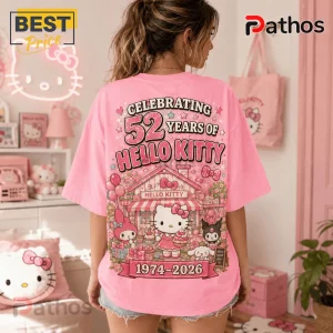 Hello Kitty 52nd Anniversary Pink T-Shirt featuring Hello Kitty, My Melody, and Kuromi graphics with 1974-2026 text.