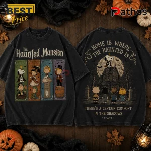 Peanuts Haunted House Halloween 2026 T-Shirt featuring Snoopy and gang in spooky costumes on a washed black cotton fabric.