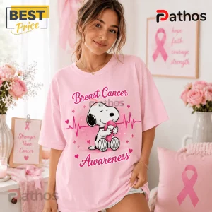 Snoopy Breast Cancer Awareness Pink T-Shirt 2026 3 Snoopy Breast Cancer Awareness Pink T-Shirt 2026 featuring a Snoopy illustration with a heartbeat line and pink ribbon.