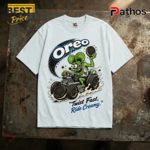 Oreo Rat Fink Midnight Cookie Circuit White T-Shirt 1 Oreo Rat Fink Midnight Cookie Circuit white t-shirt featuring a green cartoon rodent driving a cookie-wheeled hot rod.