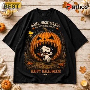 Peanuts Great Pumpkin Halloween 2026 T-Shirt 2 Peanuts Great Pumpkin Halloween 2026 T-Shirt featuring Snoopy running from a large jagged-toothed jack-o'-lantern on black.