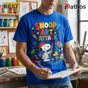 Snoopy Art Attack Royal Blue T-Shirt worn by a person, featuring a graphic of Snoopy as a painter with Woodstock.