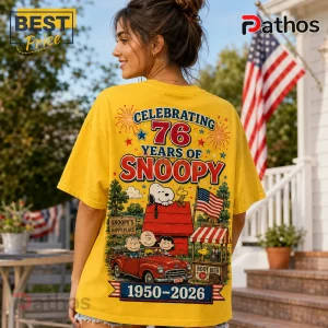 Snoopy 76th Anniversary Patriotic Yellow T-Shirt 4 Snoopy 76th Anniversary Patriotic Yellow T-Shirt features cartoon characters, a classic red car, and American flag graphics.
