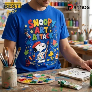 Snoopy Art Attack Royal Blue T-Shirt featuring Snoopy wearing a beret, holding a paintbrush, surrounded by art supplies.