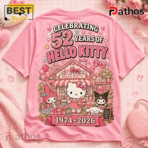 Hello Kitty 52nd Anniversary Pink T-Shirt features a graphic of Hello Kitty, My Melody, and Kuromi at a cupcake shop.