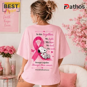 Snoopy Breast Cancer Awareness Pink T-Shirt 2026 4 Snoopy Breast Cancer Awareness Pink T-Shirt 2026 featuring a pink ribbon graphic and supportive text on a pastel pink shirt.