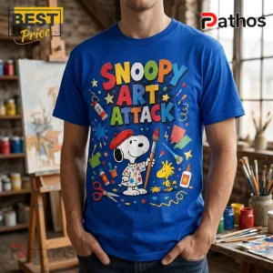 Snoopy Art Attack Royal Blue T-Shirt featuring Snoopy holding a paintbrush with Woodstock in a creative craft studio setting.