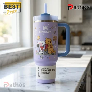Snoopy x Winnie the Pooh Lavender 40oz Tumbler with cartoon graphics, blue handle, and a straw on a marble countertop.