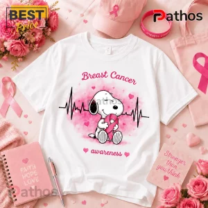 Snoopy Breast Cancer Awareness Heartbeat T-Shirt featuring a Snoopy character holding a pink ribbon on a white background.