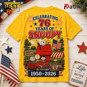 Snoopy 76th Anniversary Patriotic Yellow T-Shirt 2 Snoopy 76th Anniversary Patriotic Yellow T-Shirt featuring Peanuts characters, a red doghouse, and US flag graphics.